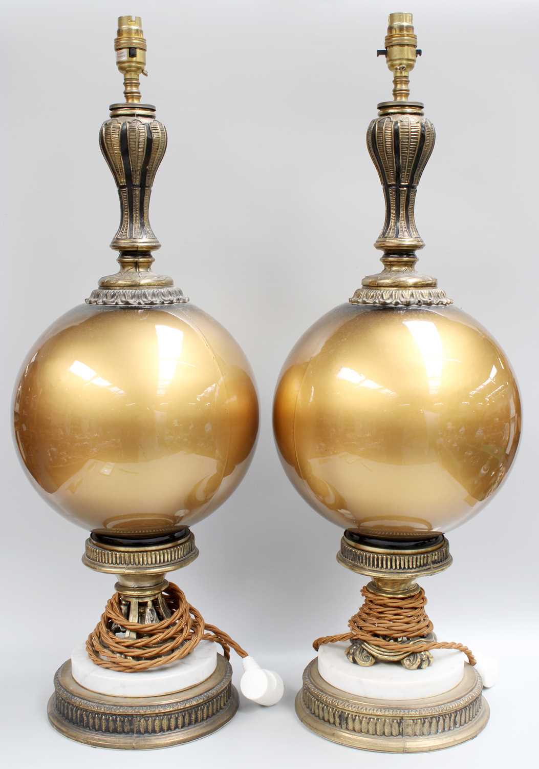 A Large Pair of Table Lamps, gilt metal and marble and with spherical glass pedestals, 73cm