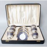 A Cased Twelve Piece Coffee Set, Bishop China, with gilt highlighting on a blue ground, comprising