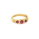 An 18 Carat Gold Synthetic Ruby and Diamond Ring, three graduated oval cut synthetic rubies