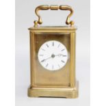 A Brass Carriage Timepiece, with enamel dial, together with a pair of pewter three light candelabra,