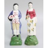A Pair of 18th/19th-century Pottery Figures, Portabello colours (with labels for DM & P Manheim, New