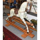 A Painted Fibre Glass Dapple Grey Rocking Horse, on a pine trestle base, plaque marked ''Haddon