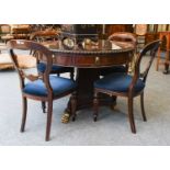 A Reproduction Regency Style Drum Table, with ring and lion mask handle on a wasted triform base and