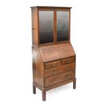 A Gordon Russell War Department Mahogany Bureau Bookcase, the glazed upper section with two