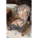 A Victorian Mahogany Spoon Backed Nursing Chair, ornately carved with a floral crest rail and the