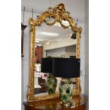 A Reproduction Gilt Framed Mirror, ornately moulded with floral swags, scrolls and acanthus