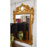 A Reproduction Gilt Framed Mirror, decorated with floral foliate swags, 79cm by 122cm