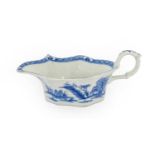 A Bow Porcelain Sauceboat, circa 1755, of lobed oval form, painted in underglaze blue with the