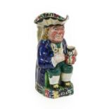 A Yorkshire Prattware Toby Jug, circa 1810, of traditional form with caryatid handle and ruddy face,