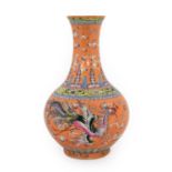 A Chinese Porcelain Bottle Vase, bears Qianlong reign mark, painted in famille rose enamels with a