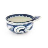 An English Delft Porringer, 18th century, of circular form with single pierced lug handle, painted