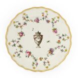 A Chelsea Derby Porcelain Plate, circa 1775, painted en grisaille with a classical urn within floral