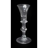 A Baluster Wine Glass, circa 1720, the trumpet bowl with basal air tear and blade knop, on a stem