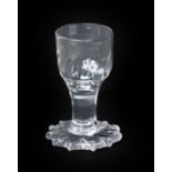 A Dram Glass, circa 1750, the fluted ovoid bowl on plain stem and overstrung foot9.5cm high