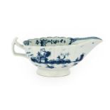 A Worcester Porcelain Sauceboat, circa 1758, of fluted oval form, painted in underglaze blue with