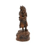 A Japanese Carved Wood Okimono of Sennin Chinnan, Edo period, standing holding his alms bowl, the