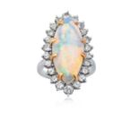 An Opal and Diamond Cluster Ring the oval cabochon opal in a yellow claw setting, within a border of
