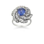 A Sapphire and Diamond Cluster Ringthe cushion cut sapphire within a radiating border of round