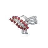 A Ruby and Diamond Broochmodelled as a ribbon tied motif, the ribbon set throughout with round