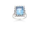 An Aquamarine and Diamond Cluster Ringthe emerald-cut aquamarine within a border of round