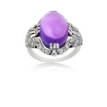 An Amethyst and Diamond Ringthe oval cabochon amethyst in a white triple claw setting, to a scroll