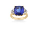 An 18 Carat Gold Tanzanite and Diamond Ringthe cushion cut tanzanite in a yellow four claw