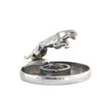 A Jaguar Chromed Car Mascot, mounted on a circular chromed ashtray base17cm diameter