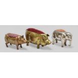 Two Brass Pig Pin Cushions and a white metal elephant pin cushion