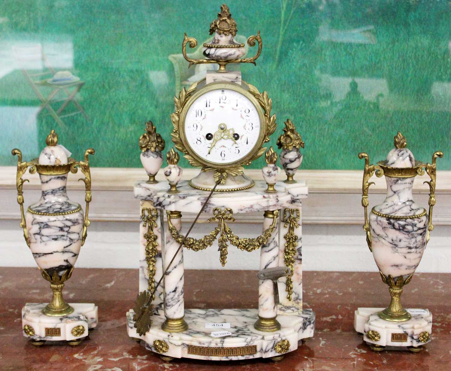 A Marble Striking Mantel Clock With Garniture, the portico clock case with gilt metal mounted swag