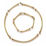 A Necklace and Matching Bracelet, five yellow plain polished chain linked graduated bamboo links,