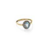 An 18 Carat Gold Blue Topaz and Diamond Cluster Ring, the oval cut blue topaz within a border of