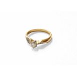 An 18 Carat Gold Diamond Solitaire Ring, with diamond set shoulders, finger size MGross weight 3.2