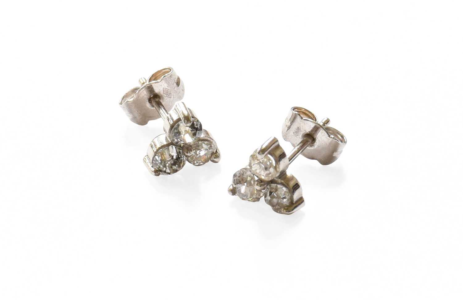 A Pair of Diamond Cluster Earrings, the trefoil motifs composed of old cut diamonds, in white claw