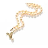 A Cultured Pearl Necklace, with a central 9 carat gold diamond drop, length 40.5cmGross weight 20.