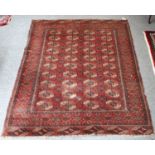 Karabagh Rug, the serrated panelled field centered by stepped indigo medallion, framed by borders of