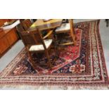 Kashgai Carpet, the raspberry lozenge field with three stepped medallions, framed by spandrels and