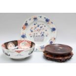 A Chinese Porcelain Imari Dish, 18th century, A Japanese Imari Bowl and A Hardwood Stand (3)