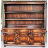 A Reproduction Oak Dresser and Rack in George III Style, the rack with two fixed shelves, the base