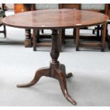 An 18th Century Oak Plank Top Tripod Table, with turned pedestal and plain scroll supports 90cm by