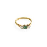 An 18 Carat Gold Emerald and Diamond Ring, the round cut emerald flanked by round brilliant cut