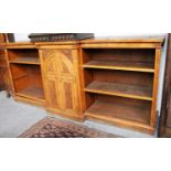 A Victorian Pollard Oak Break Front Bookcase, cross banded with reeded supports and carved arched