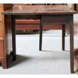 A George III Mahogany Fold Over Tea Table, with single drawers, plain spandrels and square supports,
