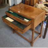 An Early 20th century Oak Canteen Table, containing a silver plated table service, with ivorine