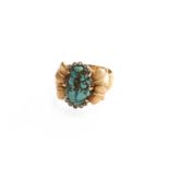 A Turquoise and Diamond Ring, the oval cabochon turquoise matrix in yellow claw settings, flanked by