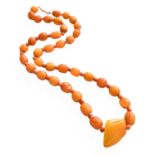 An Amber and Coral Bead Necklace, the vari-shaped and sized amber beads spaced by coral beads,
