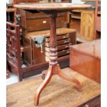 A George III Mahogany Circular Tripod Table, raised on a baluster and turned support, 58.5cm by 74.