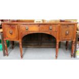 An Early 19th century Bowfront Mahogany Sideboard, with carved reeded panels, brass lion mask