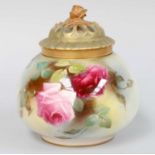 A Royal Worcester Porcelain Pot Pourri, with pierced cover and painted with roses,12cm high