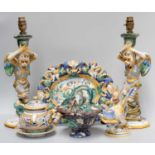 A Pair of Cantagali Faience Grotesque Figural Candlesticks mounted as table lamps, formed as