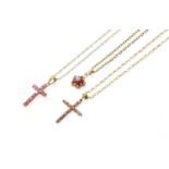 Three Pendants on Chains, comprising of a synthetic ruby and diamond cluster pendant and two cross